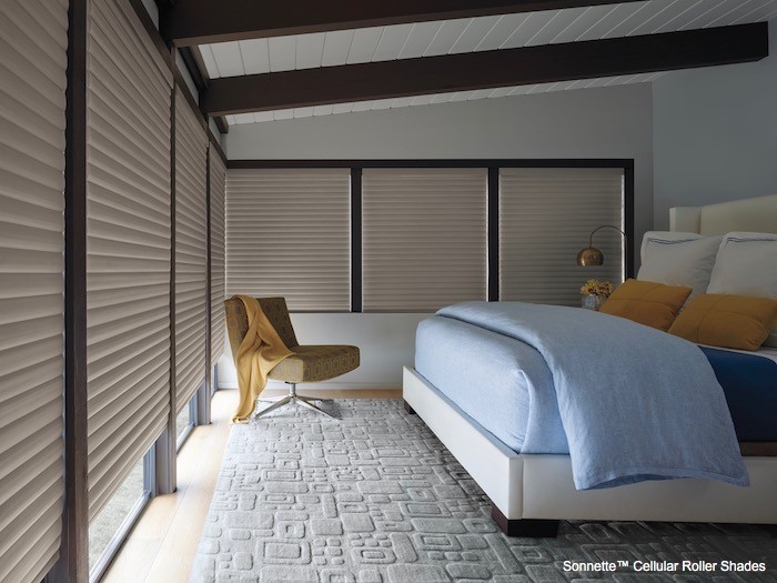 A bedroom with light blue bedding.